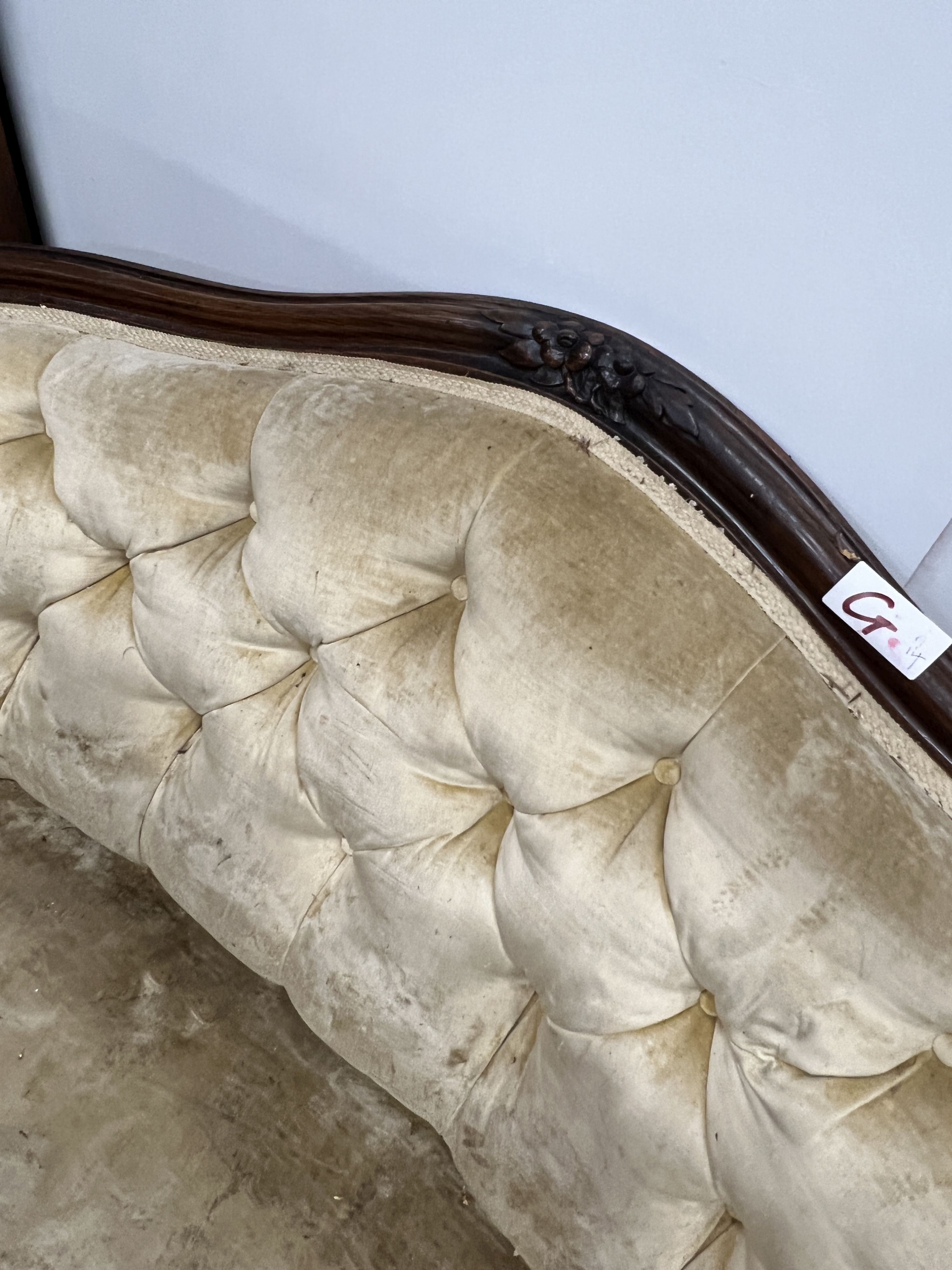 A Victorian rosewood buttonback upholstered settee, length 120cm, depth 80cm, height 84cm